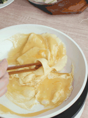 油6成熱時(shí)，下雞蛋液，邊緣凝固時(shí)翻拌成塊狀。